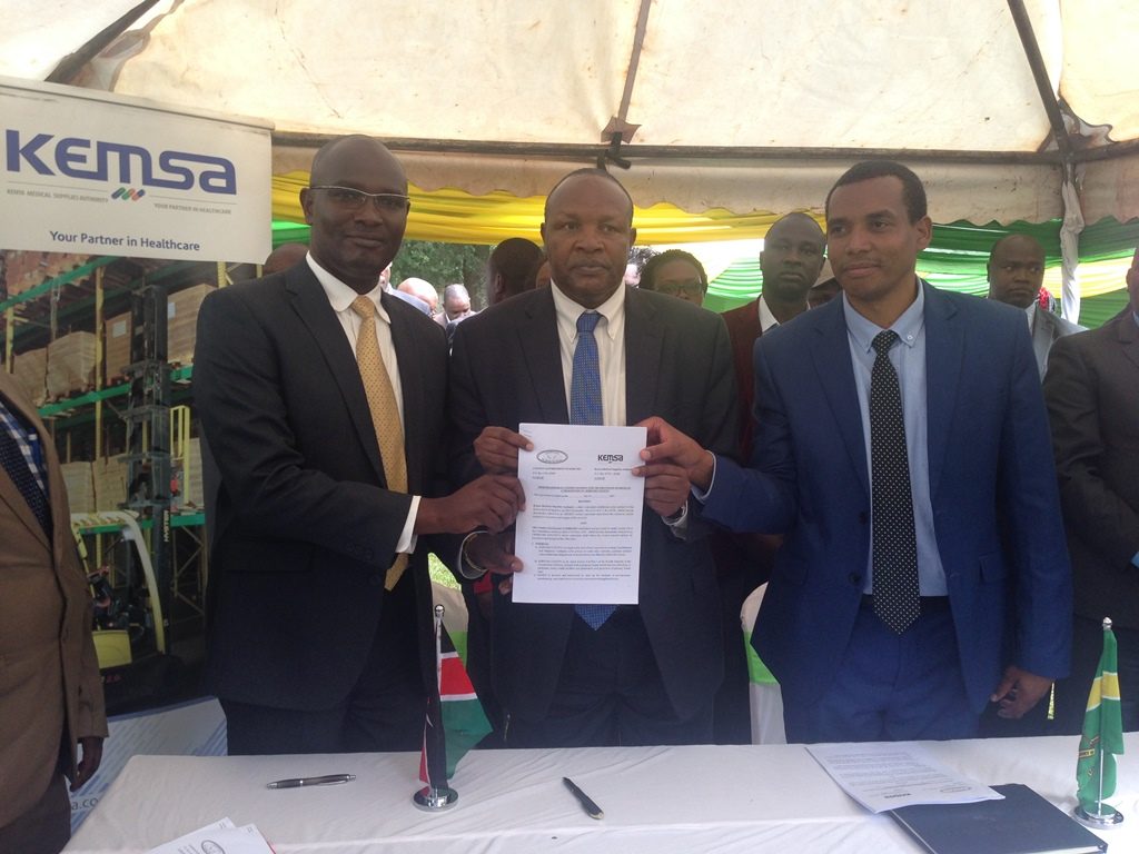 Kericho County Governor H.E Prof. Paul Chepkwony display signed MoU together with KEMSA Director Commercial Services Mr. Eliud Muriithi ( L )and Kericho County CEC Health Dr. Shadrack Mutai at Kericho
