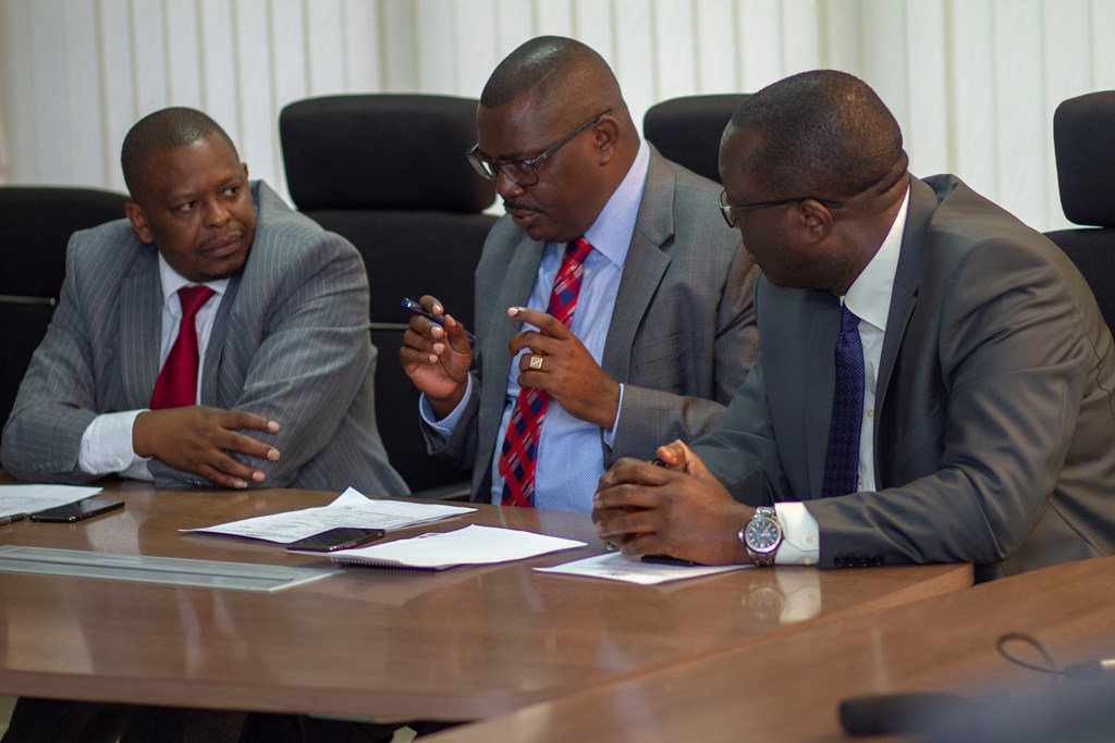 (From L) Dr. Manjari, Mr Wambua and Mr. Onyach making brief discussions during the PC signing ceremony.